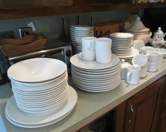 Large set of white on white dishes