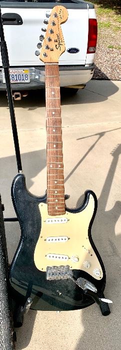 Squier Fender guitar with stand