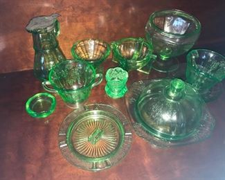 Green depression glass,  glows under black light. Includes Parrot pattern butter dish, cream and sugar.