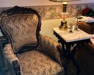 Antique easy chair and one of 2 marble top end tables.