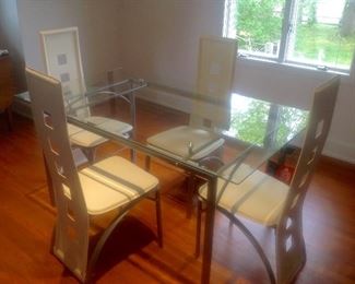 Modern tempered glass table and four white leather chairs