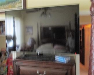 Giant 60 inch flat screen TV  connected to Bose speaker system. Bed Room  1