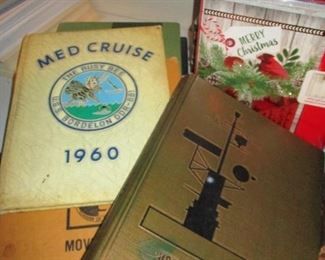 Piles of Cruise Books issued by US Navy
