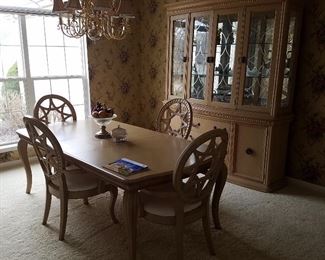 Dining room set shows extra leaf in table. There is one additional leaf not shown.