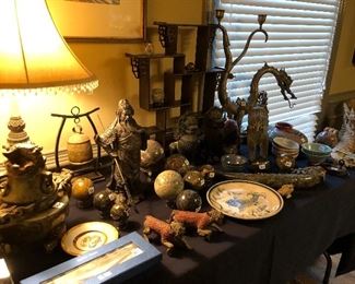 A table full of Asian pieces and carved stone balls, tons of amazing finds!