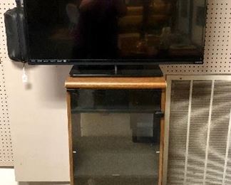 32" VIZIO TV and a Stereo Cabinet with Glass Door