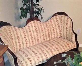 Antique settee; artificial ficus tree