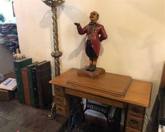 Wooden Butler Sculpture. Antique sewing machine, floor candle holder, decorative storage box