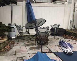 Heavy vintage black iron table with four chairs 