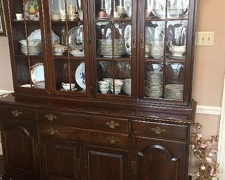 large china cabinet filled with Limoges china