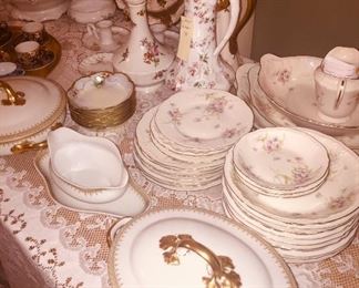 tables filled with early Haviland and Limoges china