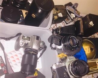 Table filled with nice working film cameras and camera lenses
