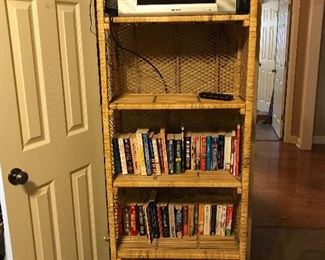 Wicker bookcase and lots of paperback books