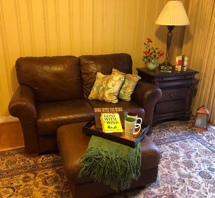 Leather loveseat and ottoman -- Holly had a bad bout of food poisoning this week so wine-induced captions are going to be mewling and self-pitying and they will lack wine, which is the worst part.