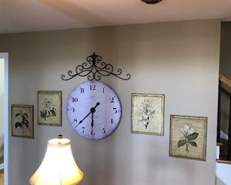 Large wall clock and floral wall art