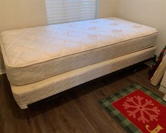Twin mattress and box springs on metal frame