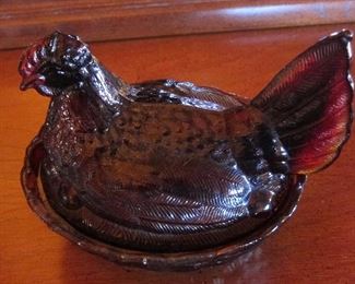 Ruby red hen on a nest