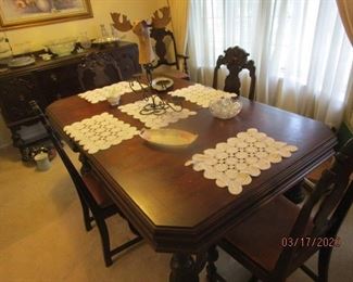 Dining Table w 5 chairs. 4 side chairs. 1 Arm chair. Appears to be mahogany. Pictured with one leaf inserted.