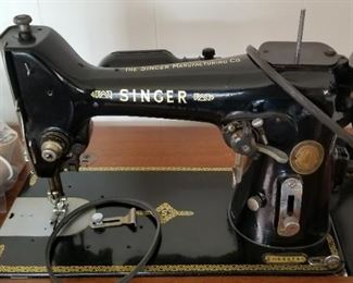 Early electric Singer sewing machine in pristine antique cabinet