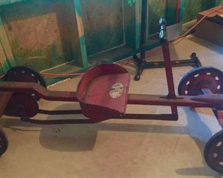 WOW- yes American pickers found one too- it’s a vintage Irish metal push cart. It still works, and yes, occasionally I hop on and ride it.