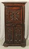 18th C. EUROPEAN CARVED OAK CABINET. CARVED UPPER DOOR AND LOWER DOORS. SIDE PANELS HAVE AN "X" DESIGN. NO LOCKS. 54" H X 26 1/2" W X 14" D.
