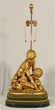 19TH C. GILT BRONZE FIGURAL CHERUB DECORATED LAMP. TWO CHERUBS WATCHING A ROOSTER. GOOD. 19 1/2" H X 17" W X 10" D.