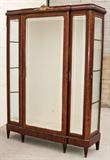 ANTIQUE FRENCH LOUIS XVI STYLE 3 DOOR VITRINE. BEVELLED GLASS ON THE DOORS AND SIDES. UPHOLSTER BACK AND ELECTRIFIED INTERIOR. ORMOLU MOUNTS. GOOD. 94" H X 67'' X W 22" D.
