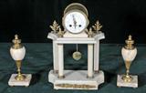 3 PC. FRENCH MARBLE & GILT BRONZE CLOCK SET. CONSISTING OF A CLOCK AND A PAIR OF URN SHAPED GARNITURES. CLOCK 1 PILLAR AS IS. CLOCK NOT WORKING. CL 14 1/2" H X 10" W X 5" D.
