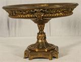 OVAL BRONZE COMPOTE WITH VINTAGE DECORATION. HEAVILY CHASED DESIGNS. GOOD. 10 1/2" H X 15 1/4" W X 11 1/4" D.