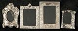 4 STERLING EASEL BACK SILVER FRAMES. THREE ARE RECTANGULAR AND ONE IS OVAL SHAPED. EMBOSSED DECORATION. GOOD. TALLEST 13 1/4" H X 9 5/8" W.