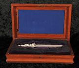 RUSSIAN SILVERED BRONZE DAGGER. MULTI FIGURAL HANDLE. THE SHEATH HAS A MACABRE DECORATION. WOODEN CASE. GOOD. 11 1/2" H X 3 1/4" W X 1" D.