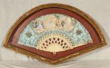 ANTIQUE HAND PAINTED FAN WITH IVORY STICKS. FIGURAL DECORATION. GILT SHADOW BOX FRAME. GOOD. 10 1/4" H X 19 1/4" W.