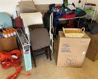 Many nice never-used outdoor chairs, two new night stands in boxes, more luggage and bags.