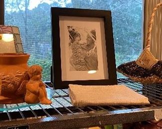 A top shelf in the bedroom filled with clay pots and other items