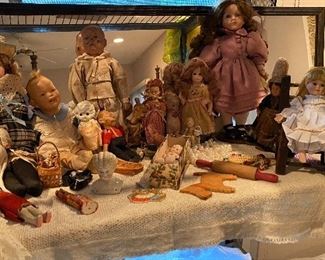 A collection of dolls from the past. Baby dolls to comic characters. Even a kewpie or two