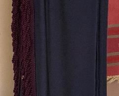 One of several heavy well made drapes in dark blue with long trim attached