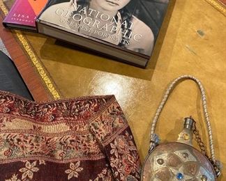 several of the great coffee table books along with a metal flask made from copper and other metals