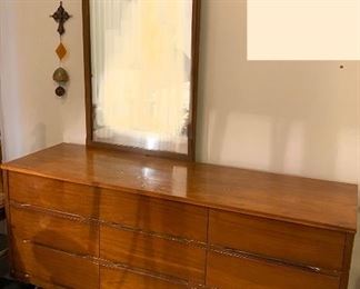 the mid century beauty. sleek lines to this modern dresser. no knobs just carved out hand pulls