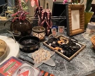 the counter top in the master bath is filled with goodies-jewelry to picture frames and so much more