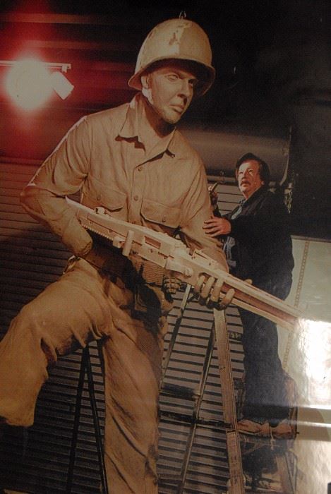 Photo of Greenville artist Gordon Thomas sculpting the clay version of his larger than life portrayal of WWII hero Audie Murphy. It was later cast in bronze and it graces the entry to the Audie Murphy/American Cotton Museum in Greenville.