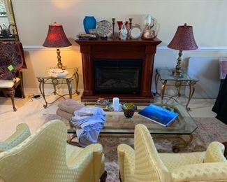 Living room brass & glass tables, Hickory wing back chairs, Stiffel table lamps, electric fireplace, vases, etc.