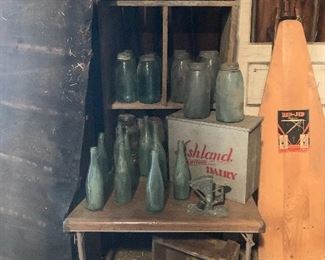 Antique large 1858 Mason canning jars, old beer bottles, Ashland Dairy cooler box, Vintage ironing board with advertising, Antique wood door