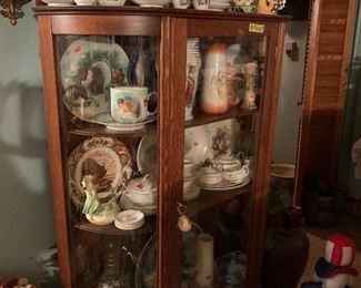 Oak china cabinet filled with antique treasures