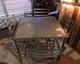 Glass patio set with four matching chairs