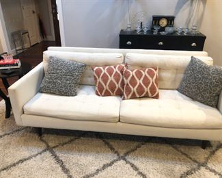 white sofa decorative pillows and rug 