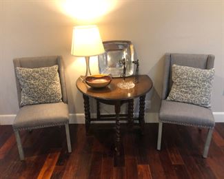 Antique tables in perfect condition with pillows, gray lien wing back chairs 