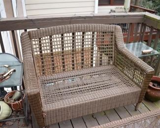 Set of resin wicker outdoor furniture. Includes navy blue cushions (not shown). Includes settee, coffee table, chairs and swivel chair