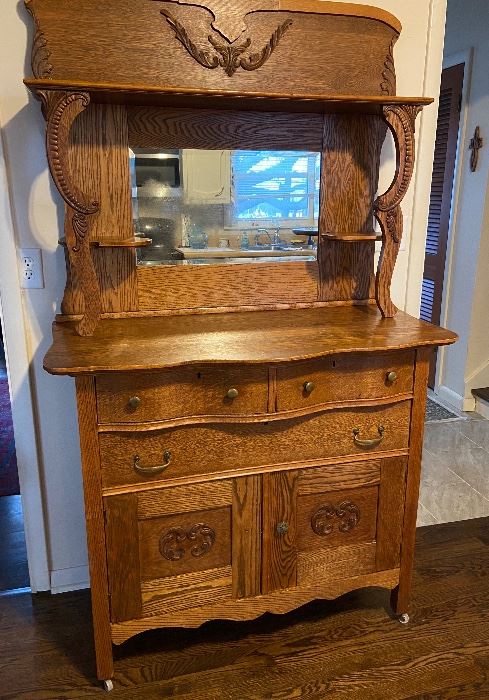 Oak buffet with beveled mirror. Two piece knockdown. Mirror is original with some fading. Original owner.  Reduced to $225 no other discount.