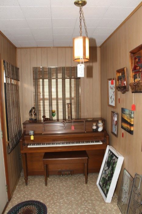 Piano ( needs tuning) Pictures on the wall, and a vintage hanging lamp in the front hall