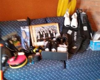 blue couch with assorted sporting goods